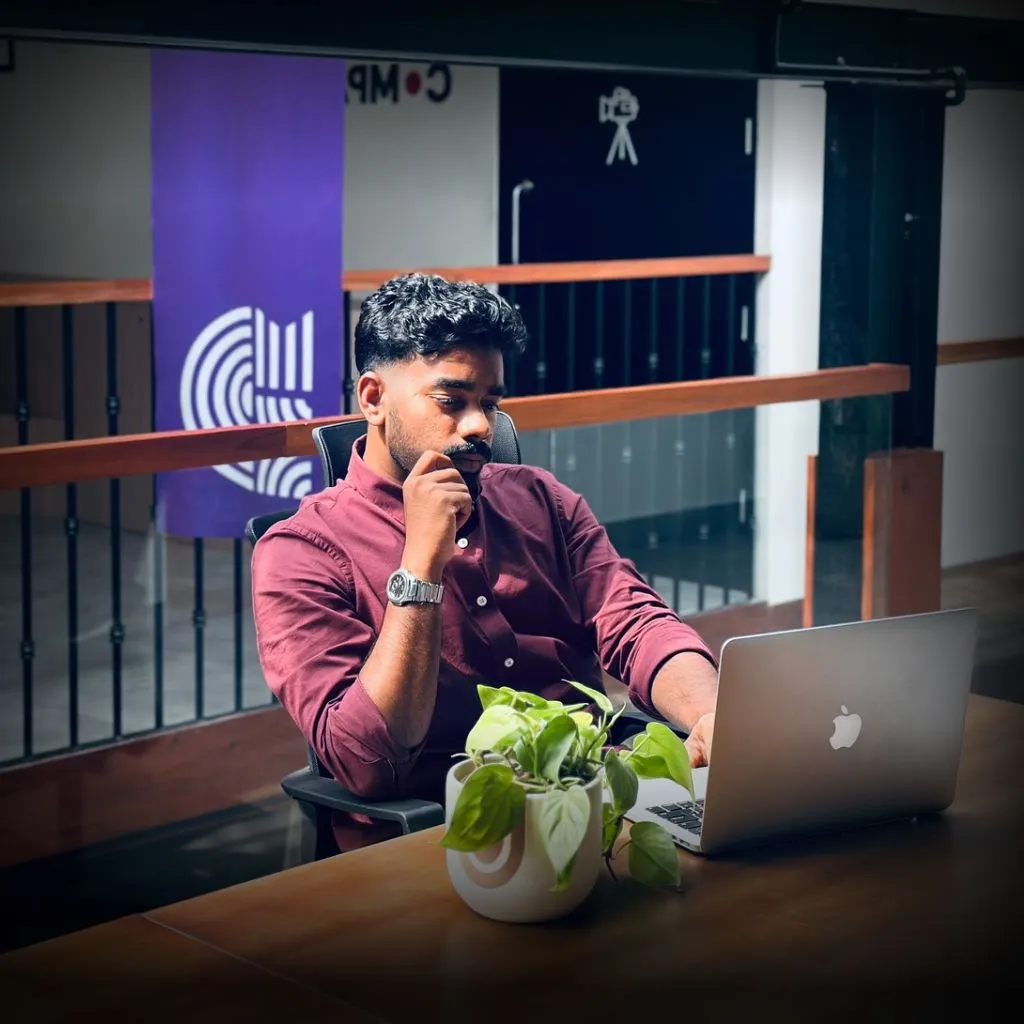 Top Digital Marketing Specialist in Qatar, sitting with his laptop